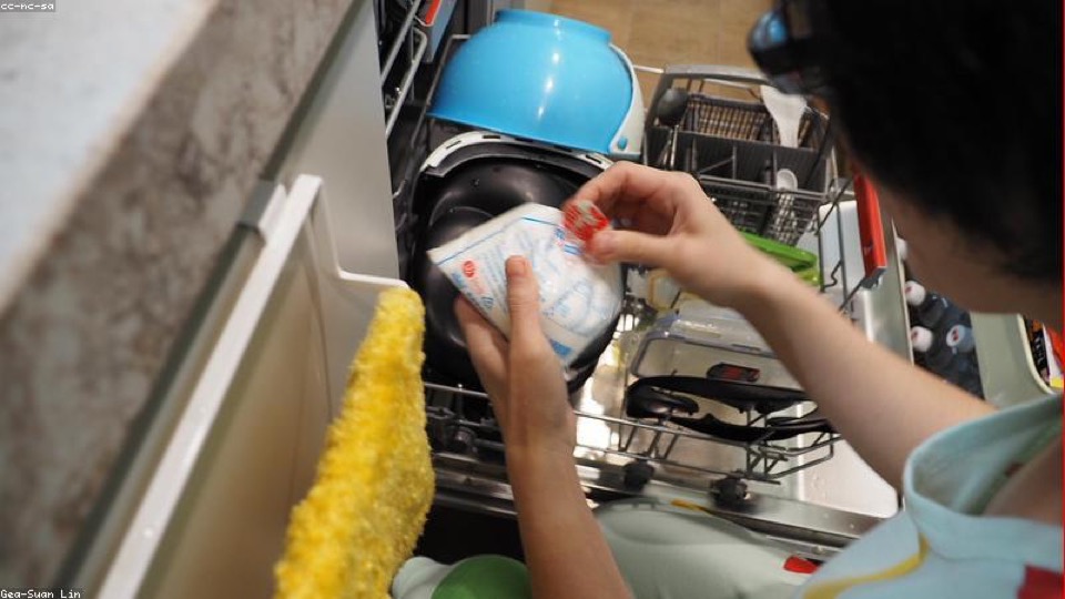 Open dishwasher with salt bag ready — hard water maintenance in Warsaw