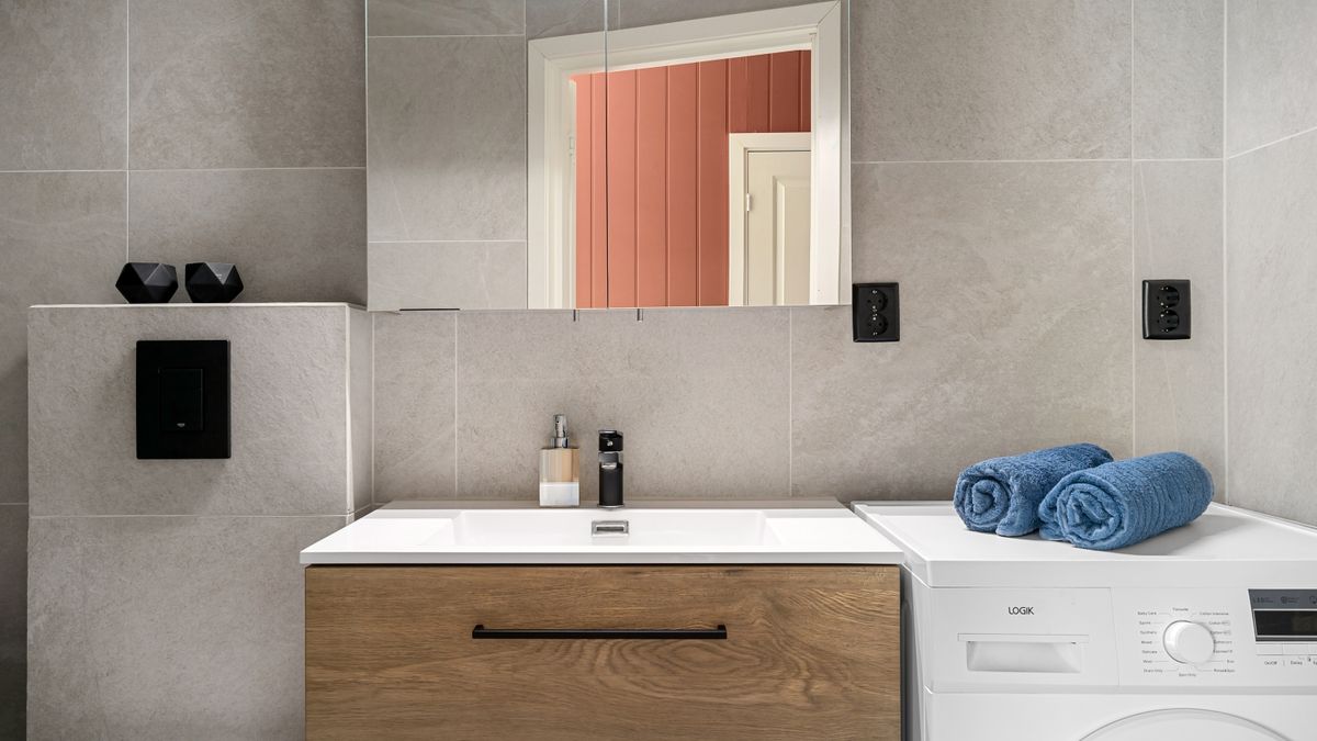 Shower leak in a Warsaw bathroom — tiles, trays, and pipework